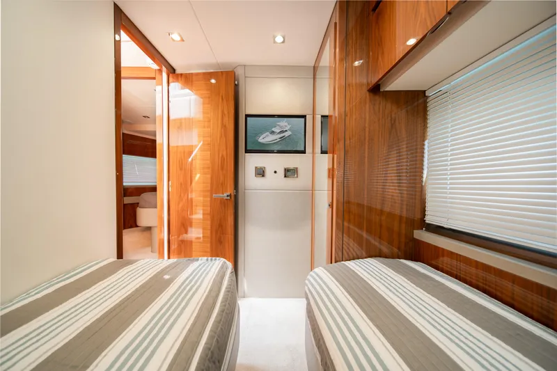 Why Knot Yacht Photos Pics Luxurious interior of 2020 Sunseeker 52 Manhattan yacht with twin beds and wooden finishes.