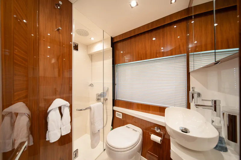 Why Knot Yacht Photos Pics Luxurious bathroom in 2020 Sunseeker 52 Manhattan yacht with modern fixtures and wood accents.