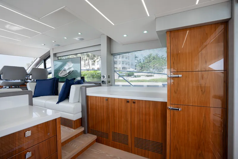 Why Knot Yacht Photos Pics Luxurious interior of 2020 Sunseeker 52 Manhattan yacht with sleek wood finishes and modern design.