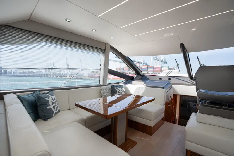 Why Knot Yacht Photos Pics Luxurious interior of 2020 Sunseeker 52 Manhattan yacht with elegant seating and modern design.