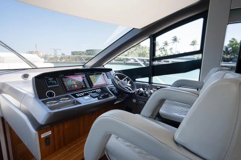 Why Knot Yacht Photos Pics Luxurious Sunseeker 52 Manhattan 2020 yacht cockpit with modern navigation system.