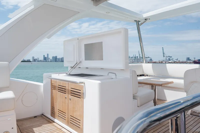Why Knot Yacht Photos Pics Luxurious Sunseeker 52 Manhattan yacht deck with seating and ocean view, 2020 model.