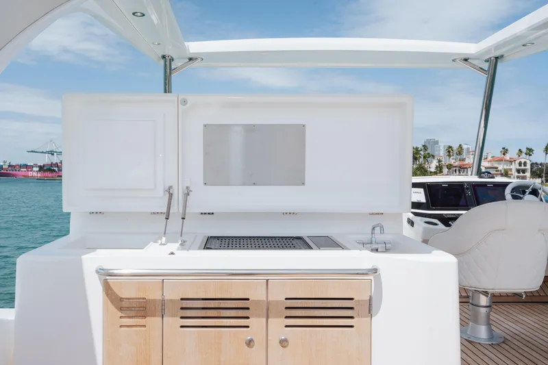 Why Knot Yacht Photos Pics Outdoor kitchen on 2020 Sunseeker 52 Manhattan yacht, featuring grill and cabinetry.