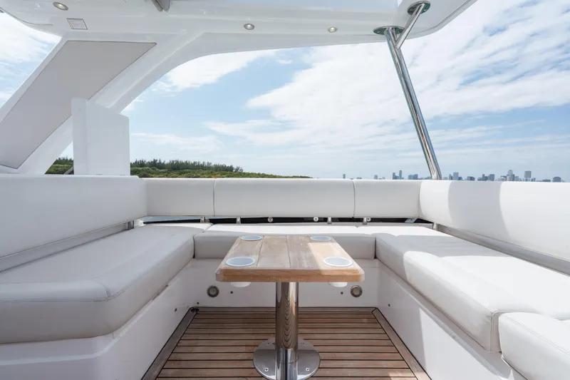 Why Knot Yacht Photos Pics Luxurious Sunseeker 52 Manhattan yacht interior with white seating and wooden table, 2020 model.