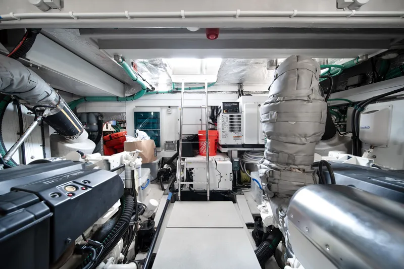 Why Knot Yacht Photos Pics Engine room of 2020 Sunseeker 52 Manhattan yacht, showcasing advanced machinery and equipment.