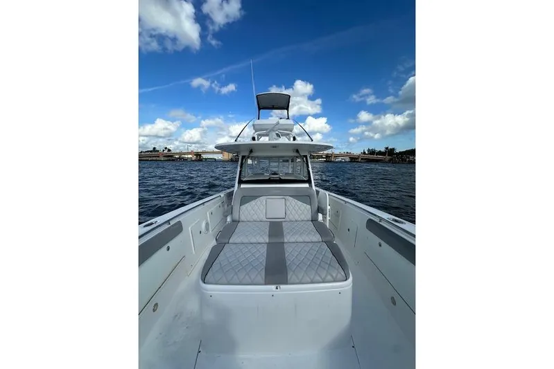  Yacht Photos Pics 2016 Everglades 435 Center Console boat on water under blue sky.
