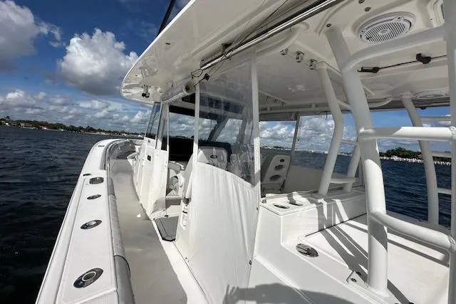  Yacht Photos Pics 2016 Everglades 435 Center Console boat on water, showcasing sleek design and spacious deck.