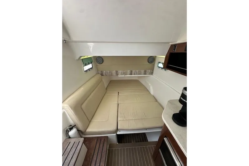  Yacht Photos Pics Interior cabin of 2016 Everglades 435 Center Console with beige seating and compact amenities.