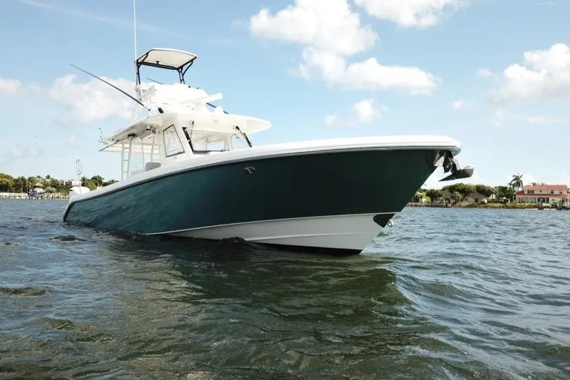  Yacht Photos Pics 2016 Everglades 435 Center Console boat on water under blue sky.