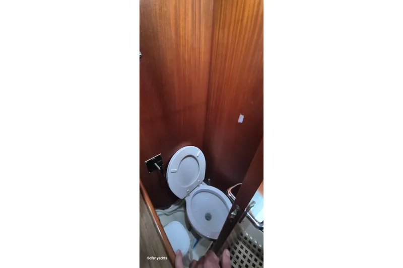  Yacht Photos Pics 1986 Hallberg-Rassy 49 yacht bathroom with wooden interior and toilet.