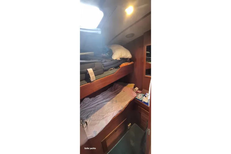  Yacht Photos Pics Interior cabin of 1986 Hallberg-Rassy 49 yacht with bunk beds and wooden finish.