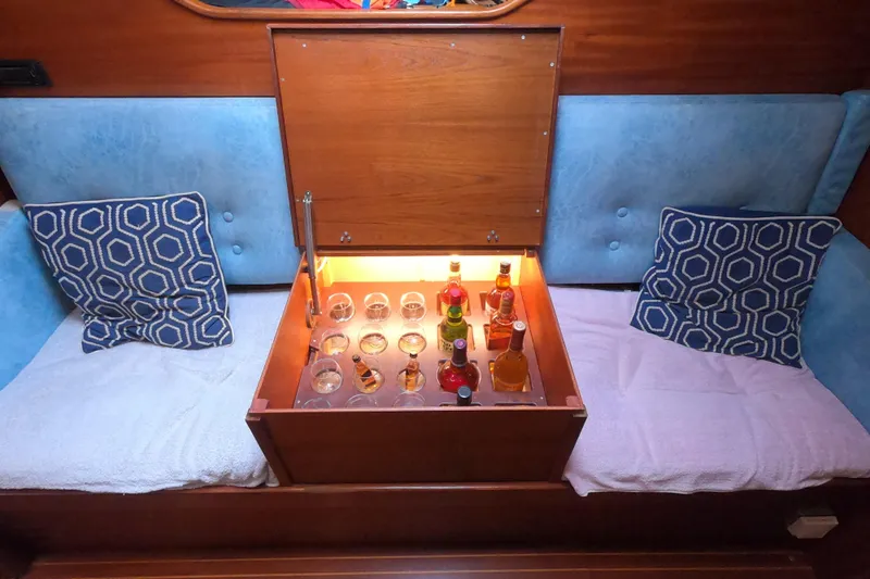  Yacht Photos Pics Luxurious 1986 Hallberg-Rassy 49 yacht interior with built-in illuminated bar and geometric cushions.