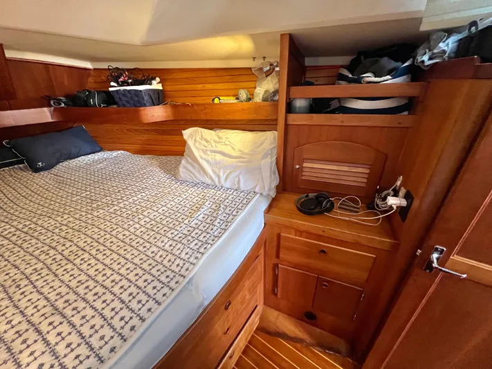 Vela Dare II Yacht Photos Pics Cozy cabin interior of a 1999 Sabre 402 sailboat with wooden furnishings.
