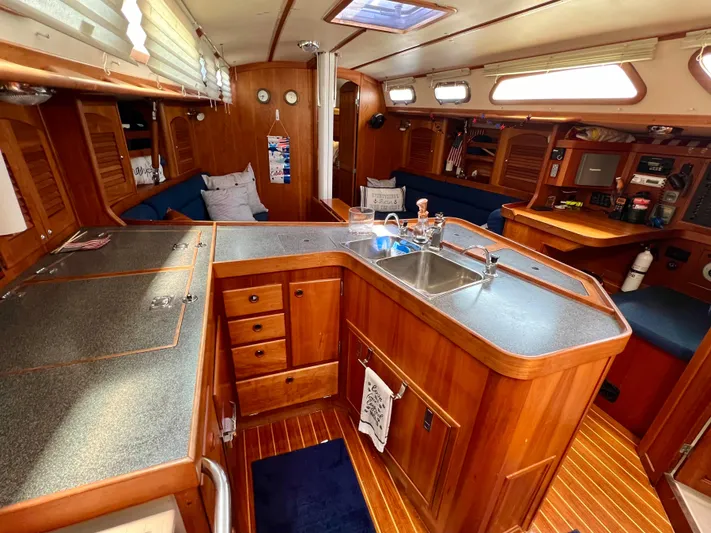 Vela Dare II Yacht Photos Pics Interior of a 1999 Sabre 402 sailboat with wooden cabinetry and a spacious galley.