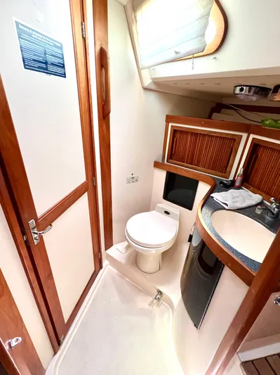 Vela Dare II Yacht Photos Pics 1999 Sabre 402 yacht bathroom with wooden accents and modern fixtures.