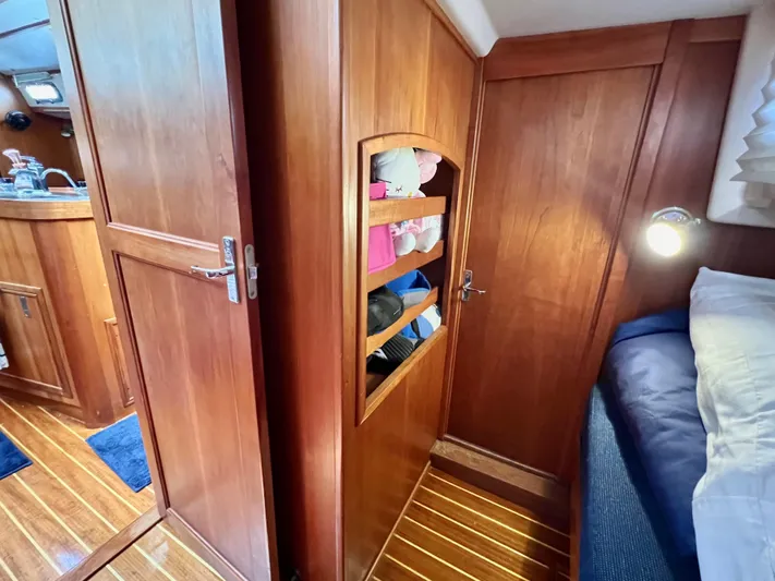 Vela Dare II Yacht Photos Pics 1999 Sabre 402 yacht interior with wooden cabinets and cozy bedroom.