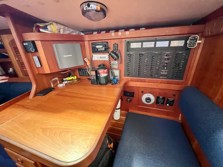 Vela Dare II Yacht Photos Pics Navigation station of a 1999 Sabre 402 sailboat with control panels and equipment.