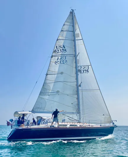 Vela Dare II Yacht Photos Pics 1999 Sabre 402 sailboat cruising on open water under clear skies