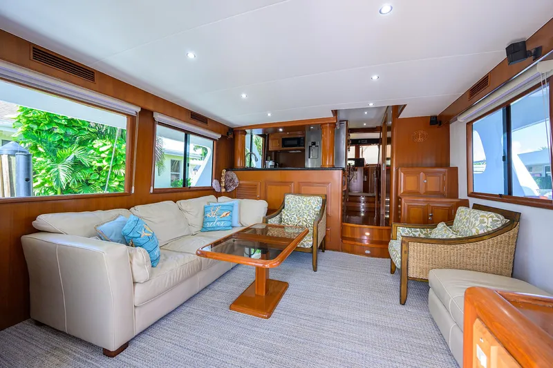 Change Of Latitude Yacht Photos Pics Luxurious interior of 2001 Ocean Alexander 602 yacht with elegant seating and wooden accents.