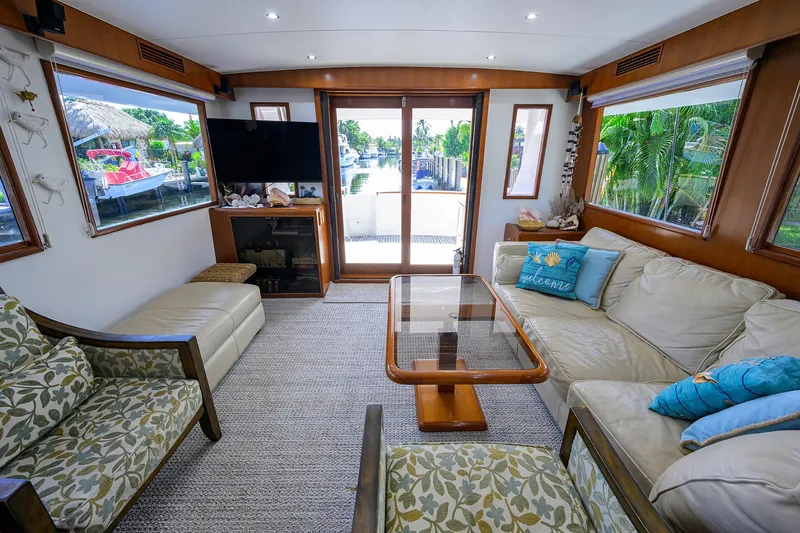 Change Of Latitude Yacht Photos Pics Luxurious interior of 2001 Ocean Alexander 602 yacht with cozy seating and large windows.