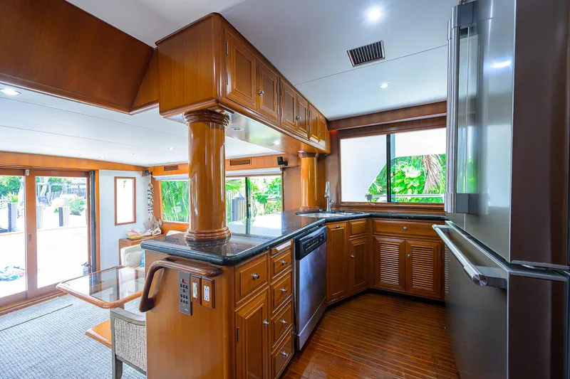 Change Of Latitude Yacht Photos Pics Luxurious kitchen interior of 2001 Ocean Alexander 602 yacht with wooden cabinetry and modern appliances.