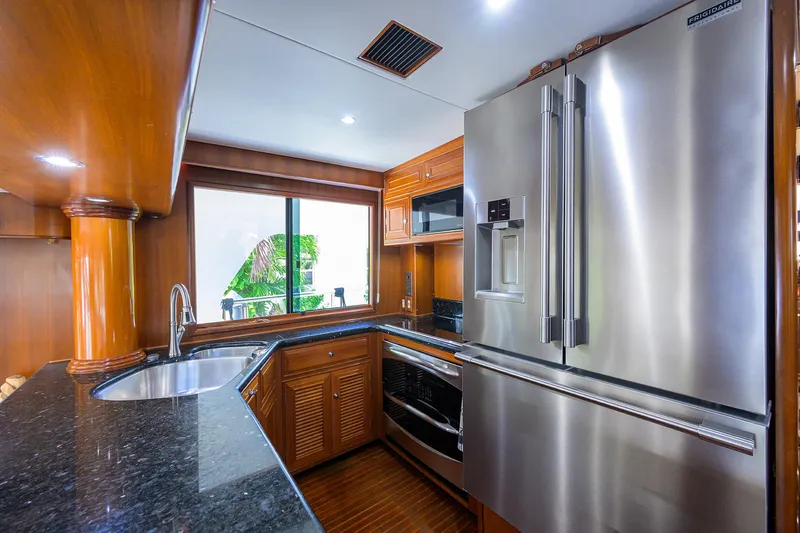 Change Of Latitude Yacht Photos Pics Luxurious kitchen in 2001 Ocean Alexander 602 yacht with stainless steel appliances and wood cabinetry.