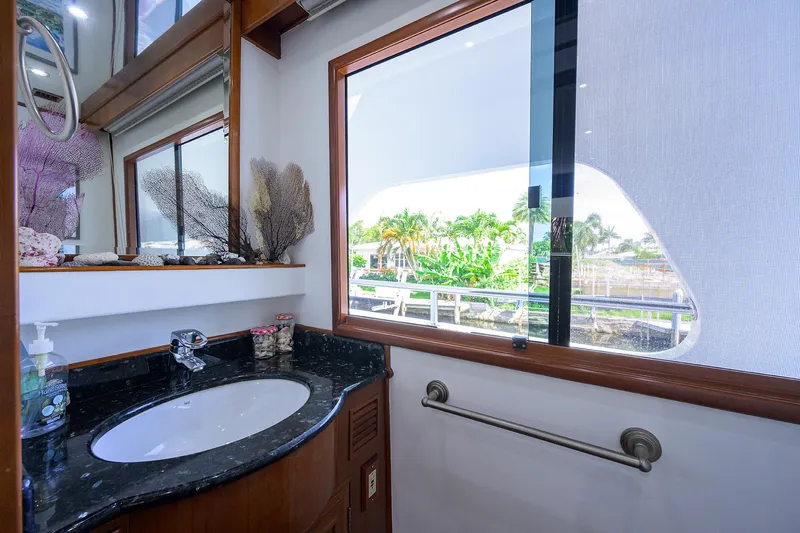 Change Of Latitude Yacht Photos Pics Luxurious bathroom interior of 2001 Ocean Alexander 602 yacht with scenic window view.