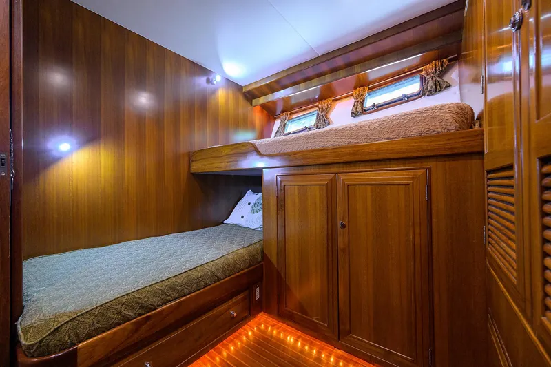 Change Of Latitude Yacht Photos Pics Luxurious wooden cabin interior of 2001 Ocean Alexander 602 yacht with cozy bunk beds.