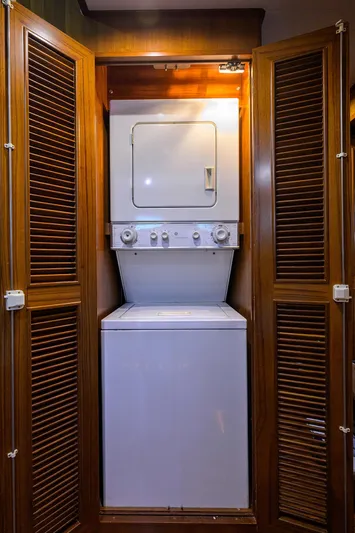 Change Of Latitude Yacht Photos Pics Stacked washer and dryer in wooden cabinet on 2001 Ocean Alexander 602 yacht.