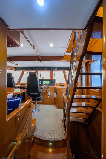 Change Of Latitude Yacht Photos Pics Interior of 2001 Ocean Alexander 602 yacht, featuring helm station and wooden staircase.