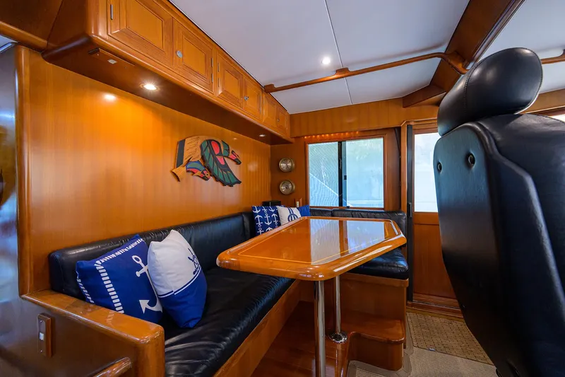 Change Of Latitude Yacht Photos Pics Luxurious interior of 2001 Ocean Alexander 602 yacht with wooden finishes and nautical decor.