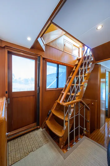 Change Of Latitude Yacht Photos Pics Interior of 2001 Ocean Alexander 602 yacht with wooden stairs and modern design.