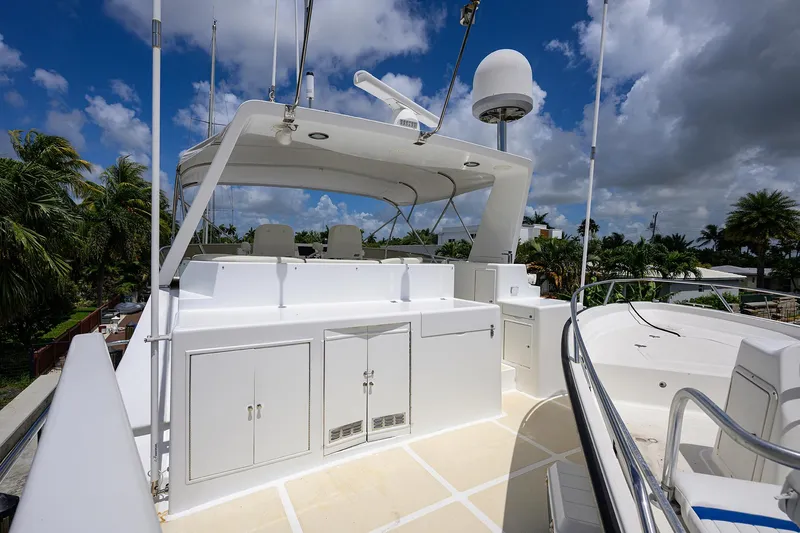 Change Of Latitude Yacht Photos Pics 2001 Ocean Alexander 602 yacht deck with seating and storage under a blue sky.
