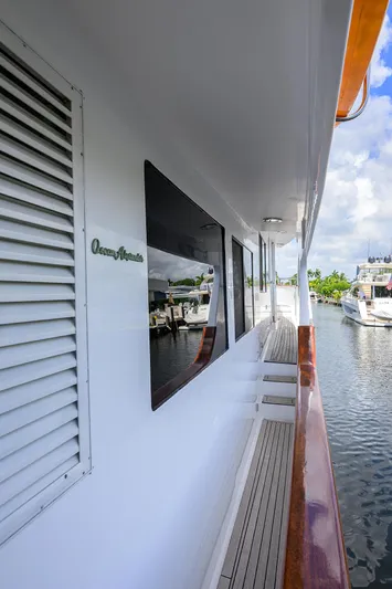 Change Of Latitude Yacht Photos Pics 2001 Ocean Alexander 602 yacht deck with wooden railings and marina view.