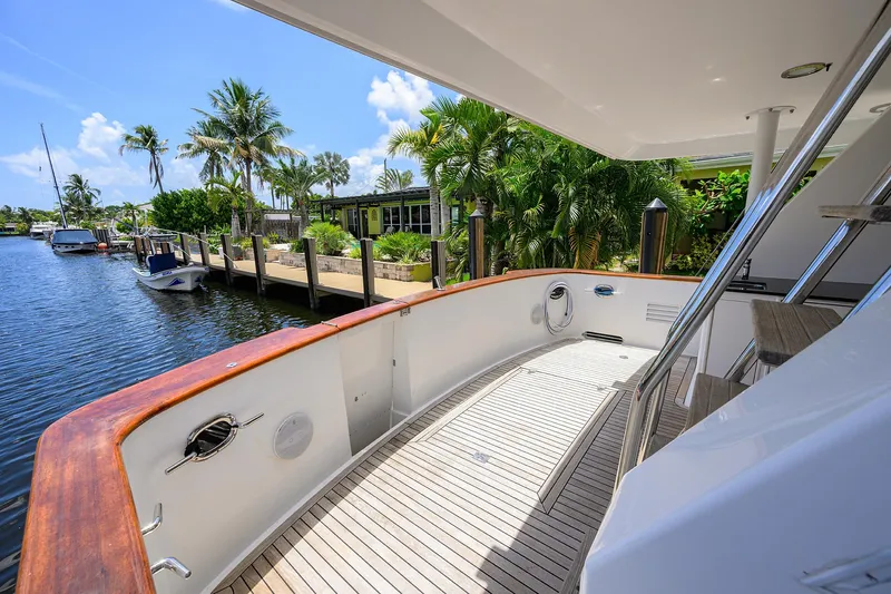 Change Of Latitude Yacht Photos Pics Luxurious 2001 Ocean Alexander 602 yacht deck with tropical waterfront view.