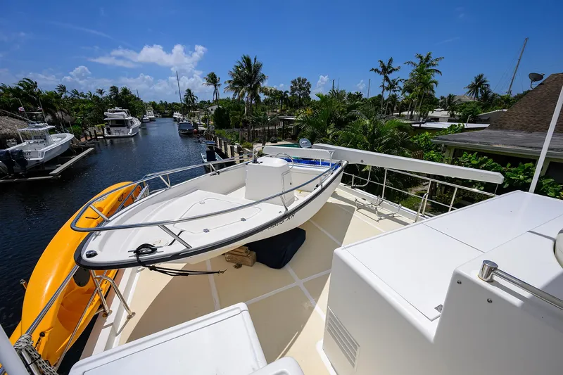 Change Of Latitude Yacht Photos Pics Ocean Alexander 602 yacht deck with lifeboat, docked in a tropical canal setting, 2001 model.
