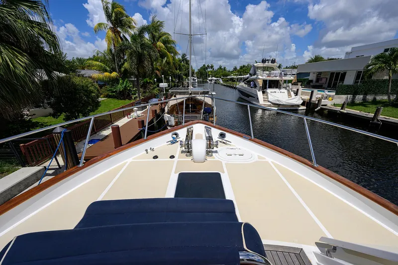 Change Of Latitude Yacht Photos Pics Ocean Alexander 602 yacht docked in a sunny canal, surrounded by palm trees, 2001 model.