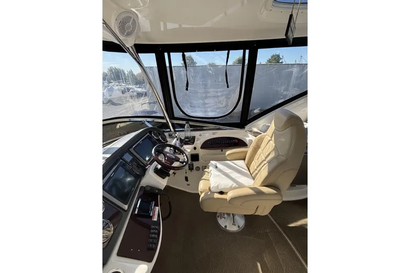 Bad Boy VI Yacht Photos Pics 2016 Meridian 441 Sedan helm with beige captain's chair and modern navigation equipment.