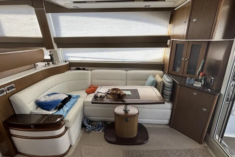 Bad Boy VI Yacht Photos Pics Interior of 2016 Meridian 441 Sedan yacht with cozy seating and elegant wood finishes.