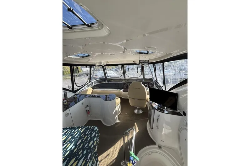 Bad Boy VI Yacht Photos Pics Interior of 2016 Meridian 441 Sedan yacht with modern helm and seating area.