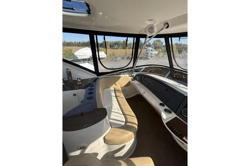 Bad Boy VI Yacht Photos Pics Interior of 2016 Meridian 441 Sedan yacht with beige seating and panoramic windows.
