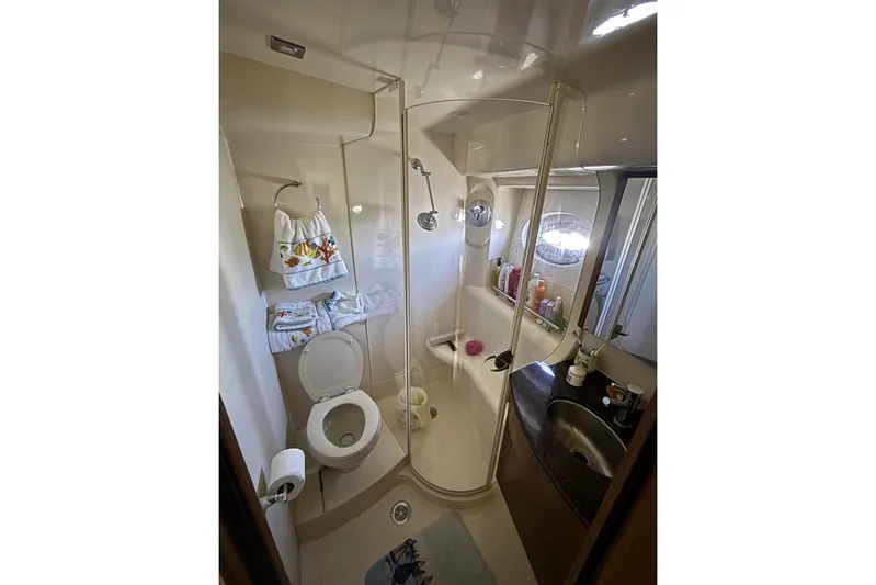 Bad Boy VI Yacht Photos Pics Bathroom interior of 2016 Meridian 441 Sedan yacht, featuring shower, toilet, and sink.