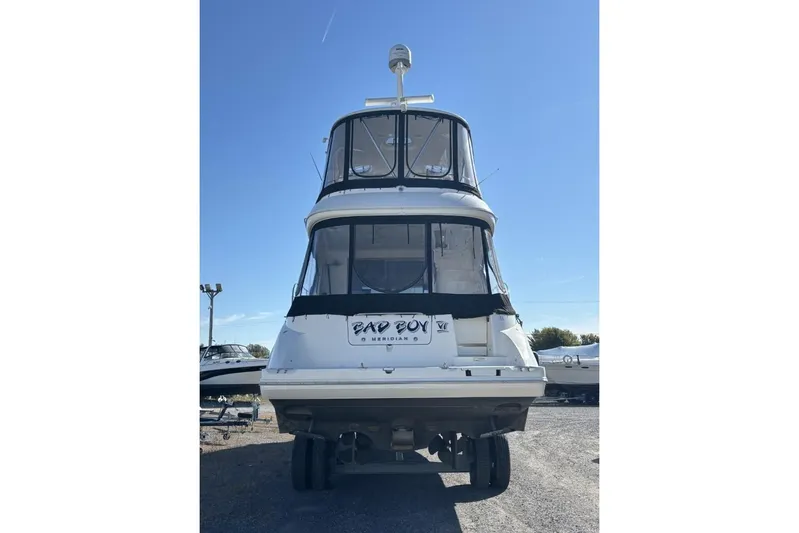 Bad Boy VI Yacht Photos Pics 2016 Meridian 441 Sedan yacht on land, rear view under clear blue sky.