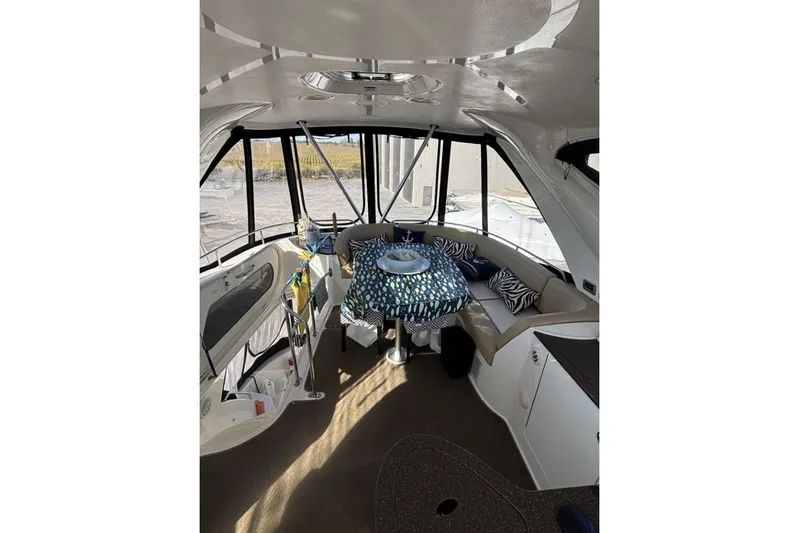 Bad Boy VI Yacht Photos Pics Interior of 2016 Meridian 441 Sedan yacht with seating and table.