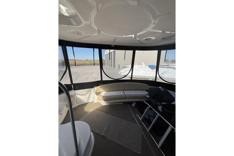 Bad Boy VI Yacht Photos Pics Interior of 2016 Meridian 441 Sedan yacht with panoramic windows and seating area.
