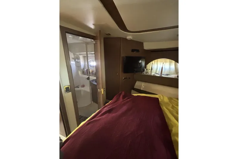 Bad Boy VI Yacht Photos Pics Interior of 2016 Meridian 441 Sedan yacht bedroom with TV and bathroom.