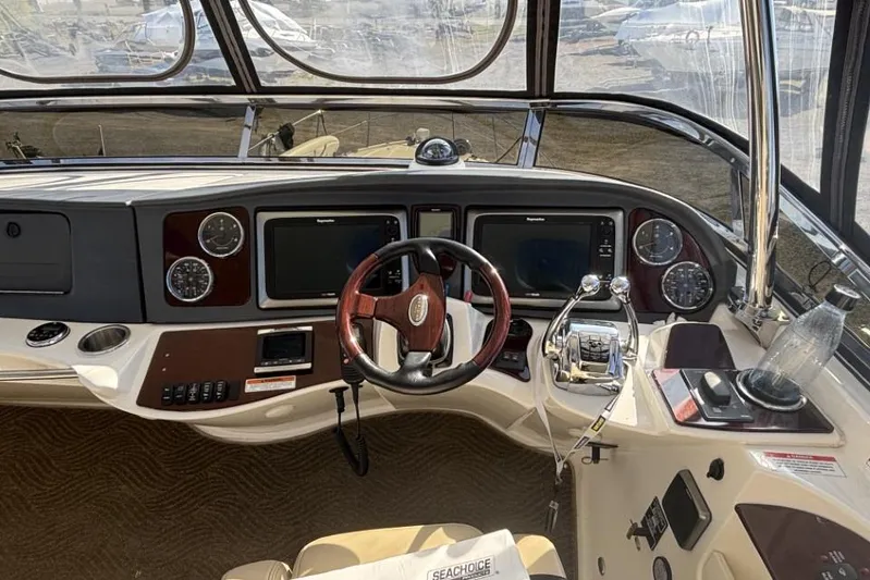 Bad Boy VI Yacht Photos Pics 2016 Meridian 441 Sedan helm with steering wheel, navigation screens, and control panels.