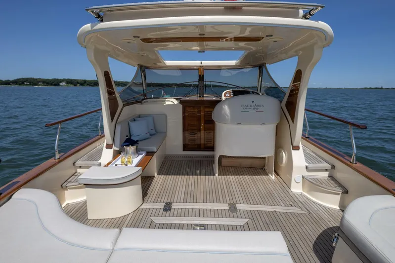  Yacht Photos Pics Luxurious 2022 Fratelli Aprea 32 Hard Top yacht interior with elegant seating and scenic ocean view.