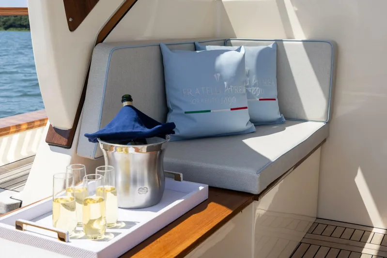  Yacht Photos Pics Luxurious seating area on 2022 Fratelli Aprea 32 Hard Top yacht with champagne.