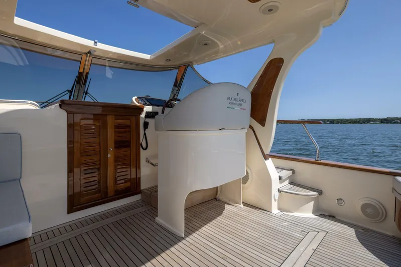  Yacht Photos Pics 2022 Fratelli Aprea 32 Hard Top yacht interior with wooden accents and helm station.